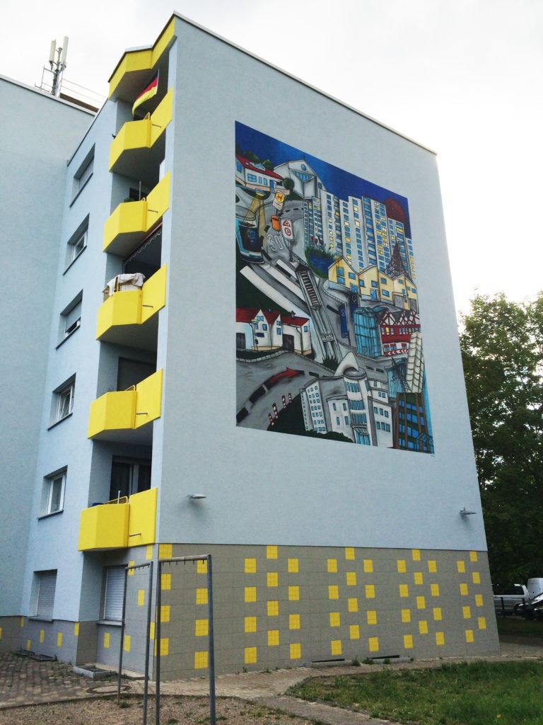 graffitiauftrag-graffitikuenstler-artmos4-Baugenossenschaft_Odenwaldring_2012_skyline_landschaft_aussen_gebäude_bunt_kunst