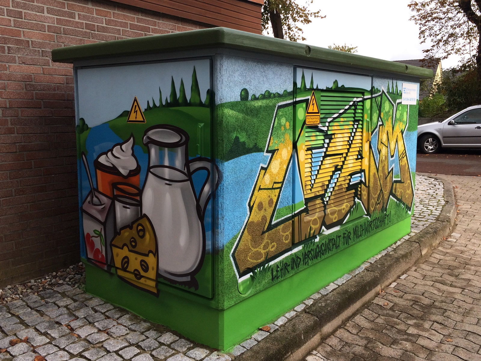 graffitiauftrag-graffitikuenstler-hansewerk-2016-graffiti-essen-landschaft-gruen-bunt-comic-aussen-energieversorger